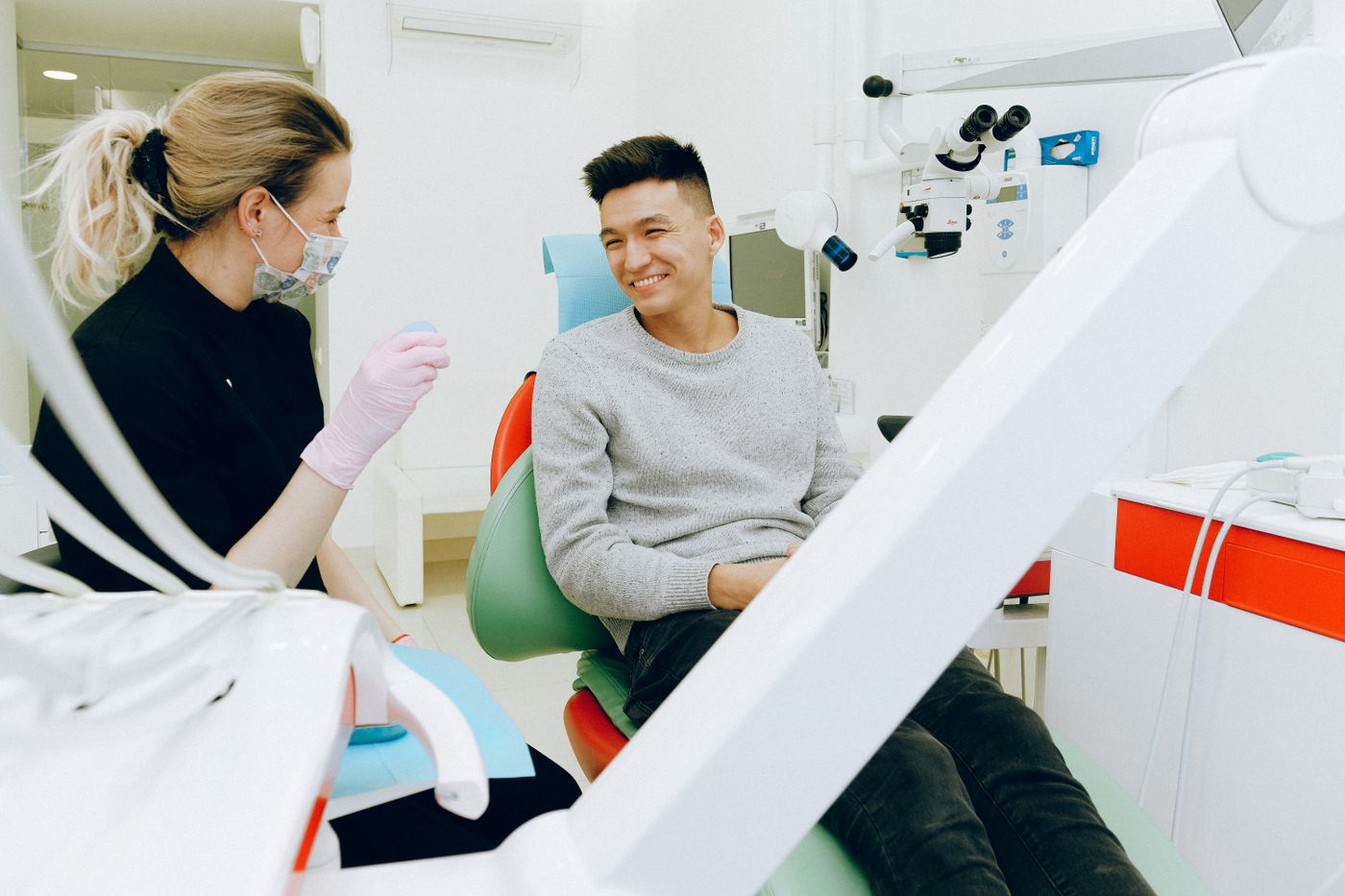 A clinician reviewing a treatment plan with a patient in a bright dental suite