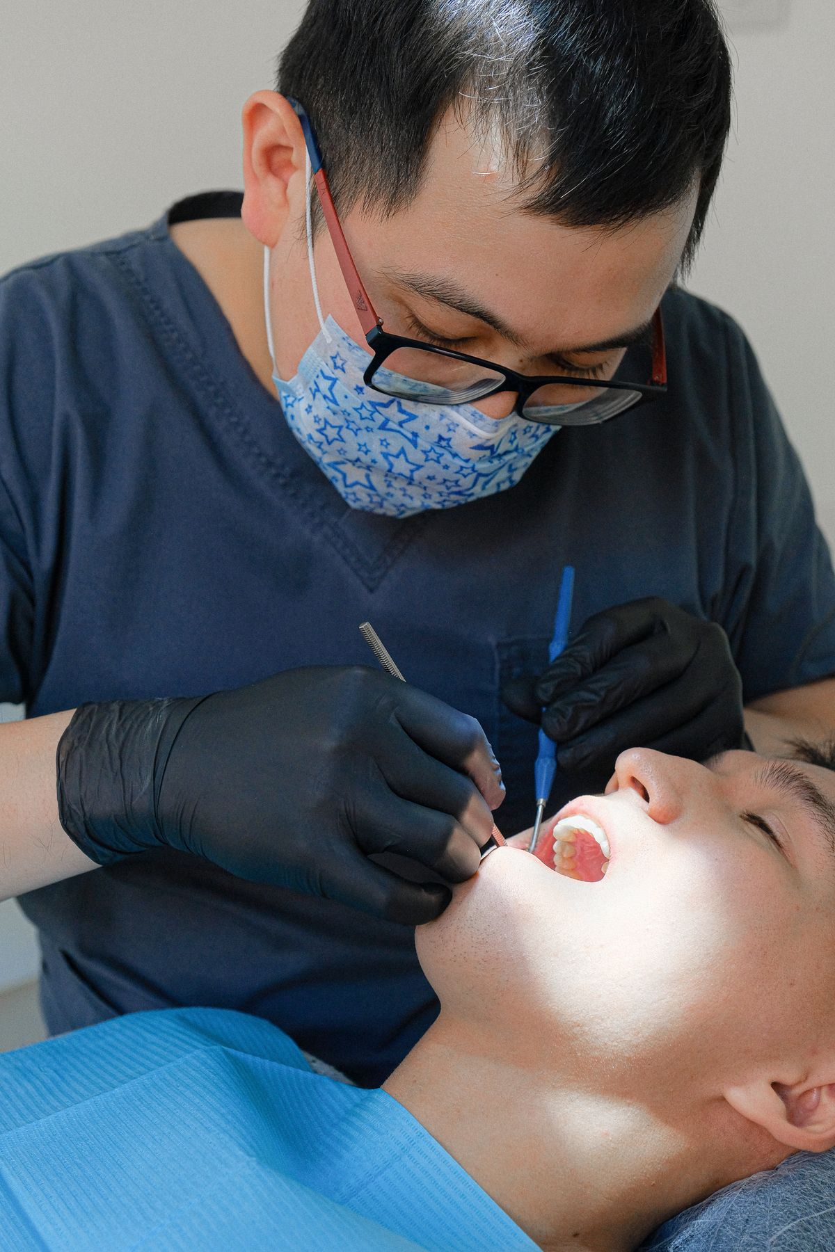A dentist working precisely on a patient