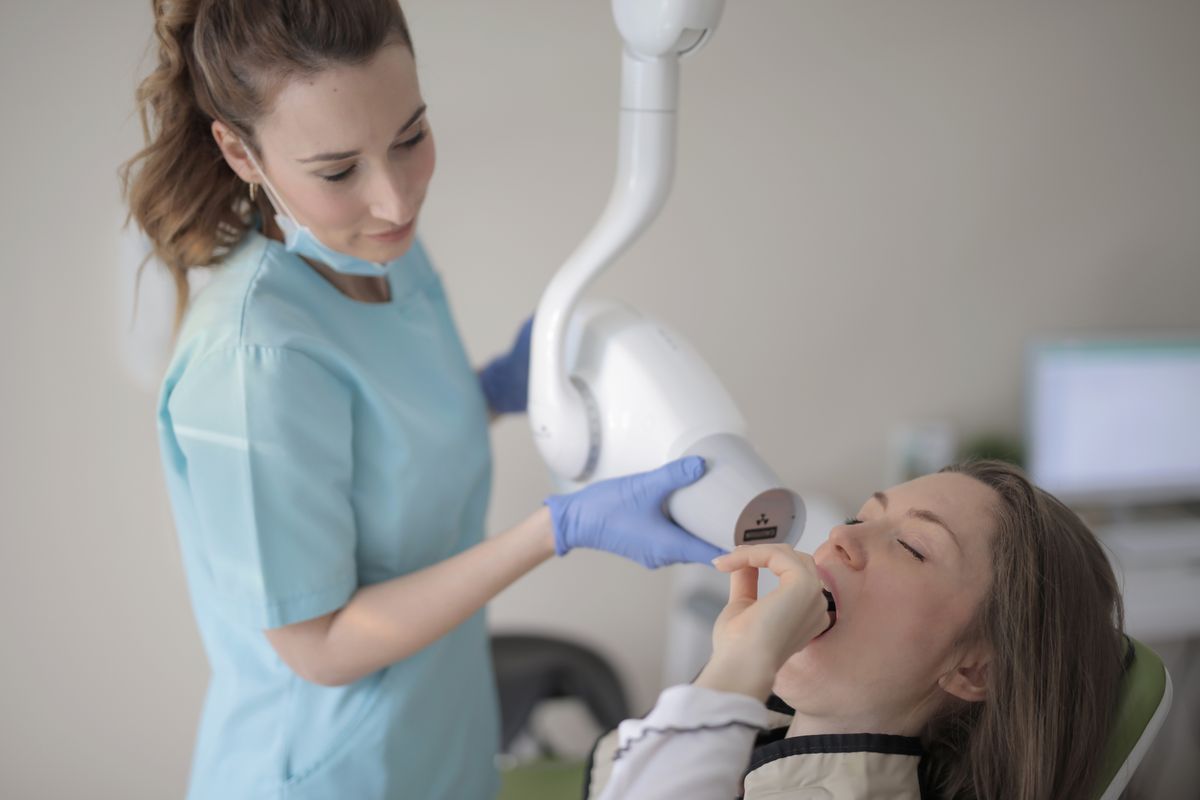 A clinician scanning a patient in the treatment chair
