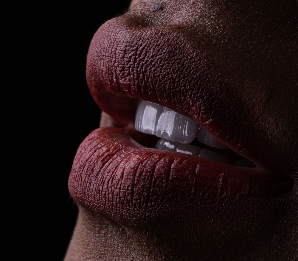 Editorial close-up of lips and teeth